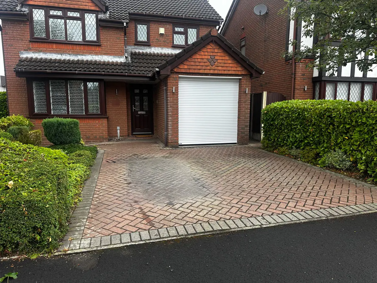 Worn block-paved driveway before replacement