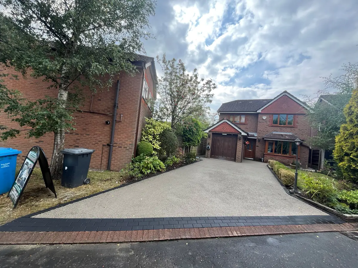 Compacted base course across the Worsley driveway with charcoal block edging set, before the resin